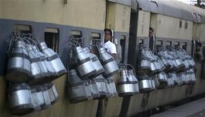 Milk containers hang from the windows of a passenger train in Ghaziabad on the outskirts of New Delhi