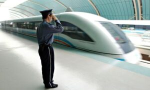 A Chinese policeman salutes as a magnetic-levitation train leaves Shanghai.