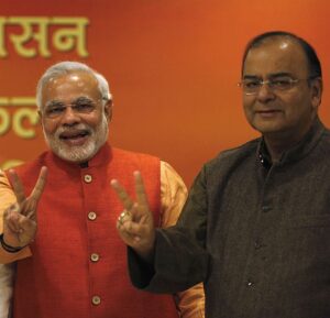 nationalist Narendra Modi, the prime ministerial candidate for BJP and leader Arun Jaitley show victory signs before their meeting in New Delhi December 8, 2013. India's Congress party was headed for a bruising defeat in key state elections, including in the capital, early results showed on Sunday, underlining the struggle it will face to cling to power in a national election due by May. The centre-left party's main opponent, the Hindu nationalist BJP, was the clear winner in three big states that went to the polls, though with the count still on it was a neck-and-neck race in a fourth. REUTERS/Ahmad Masood (INDIA - Tags: POLITICS ELECTIONS) - RTX169K4